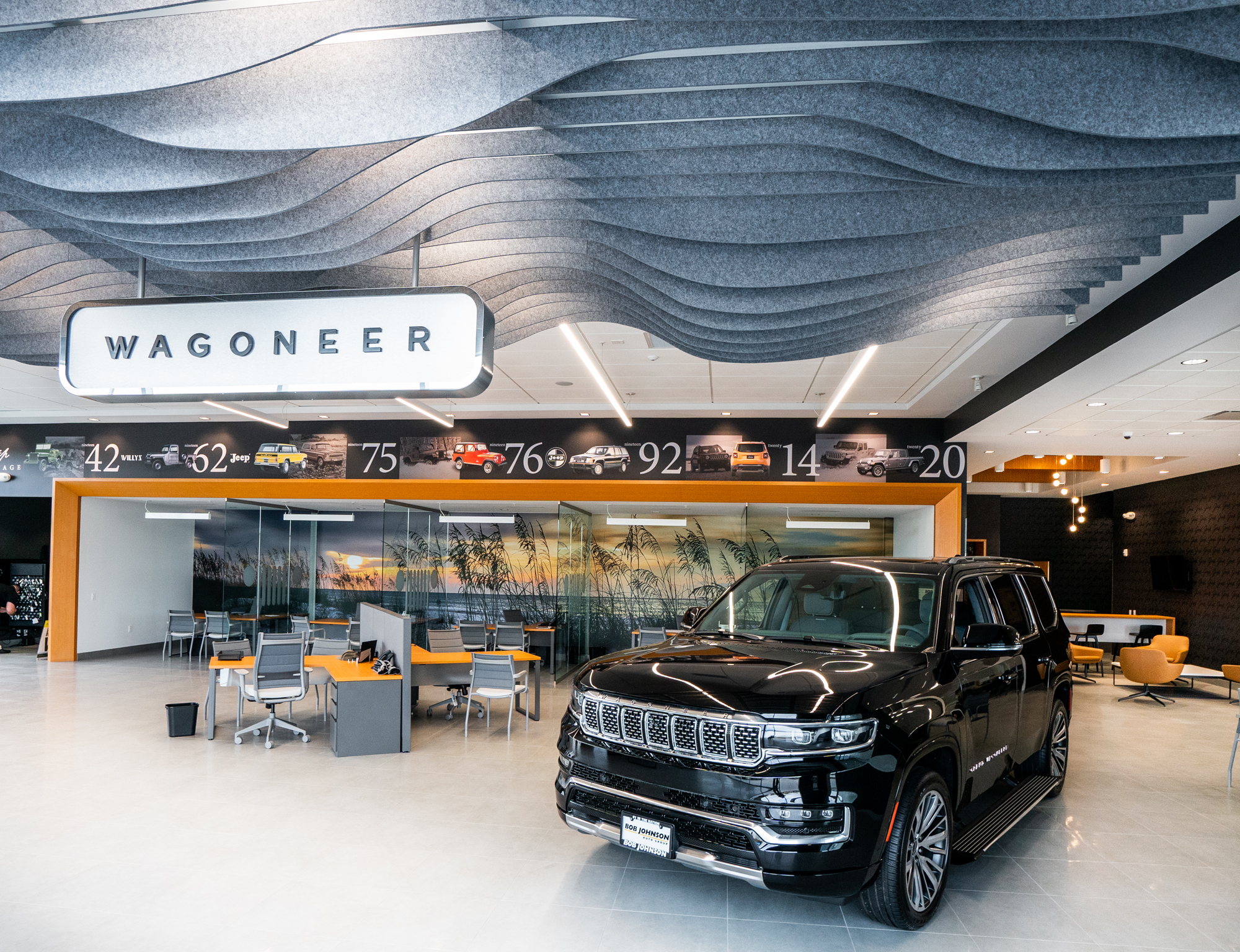 Burritt Motors modern auto showroom with seating area under a sculpted ceiling
